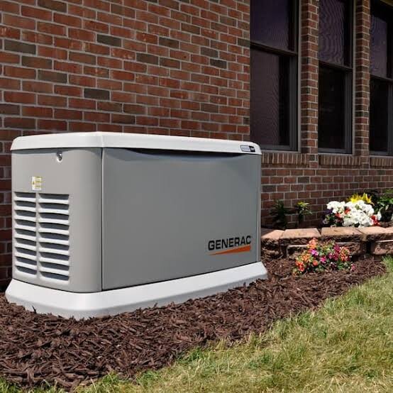 Unwrapped Generac Guardian beside a brick home